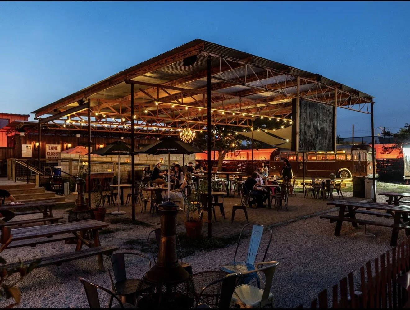 Fortune Teller’s open-air patio glowing with string lights at dusk